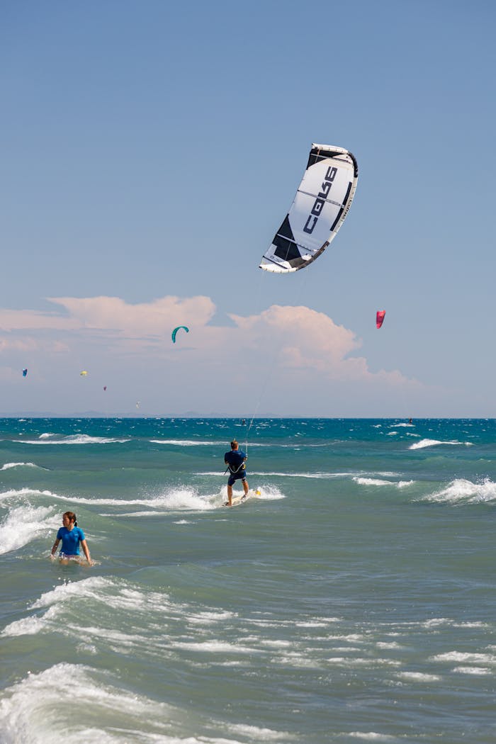 Exciting kitesurfing scene at Ulcinj beach, Montenegro under clear skies.